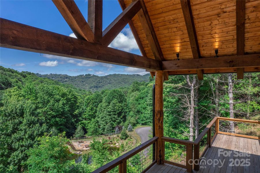 Over 1,200 square feet of outdoor space including main level porte-cochere, covered porches with majestic, private mountain & neighborhood pond views