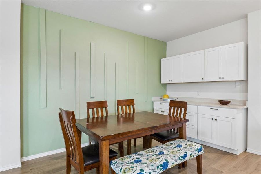 Dining area featuring baseboards and light wood finished floors Dining area featuring baseboards and light wood finished floors