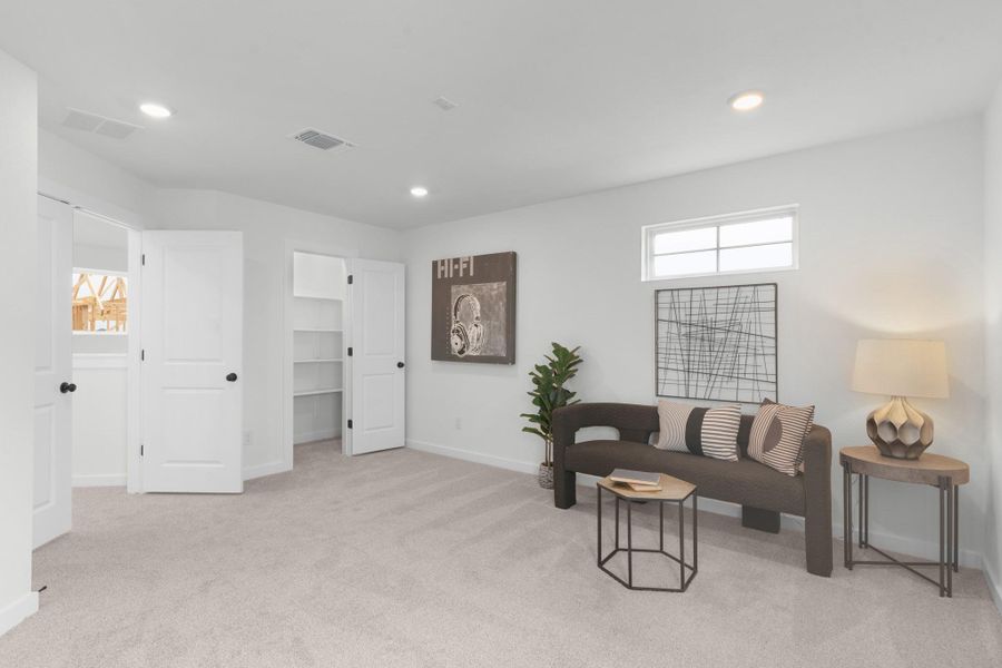 Carpeted living room featuring baseboards and recessed lighting
