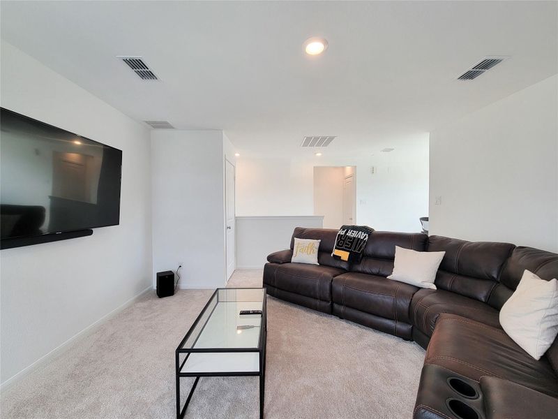 Spacious living area with modern features, and ample lighting. Ideal for relaxing and entertaining.