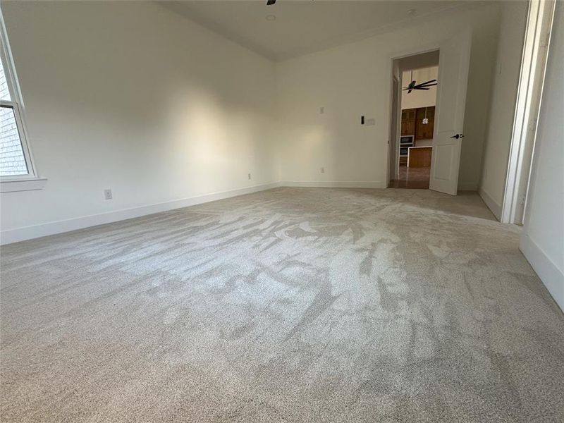 Carpeted spare room with ceiling fan