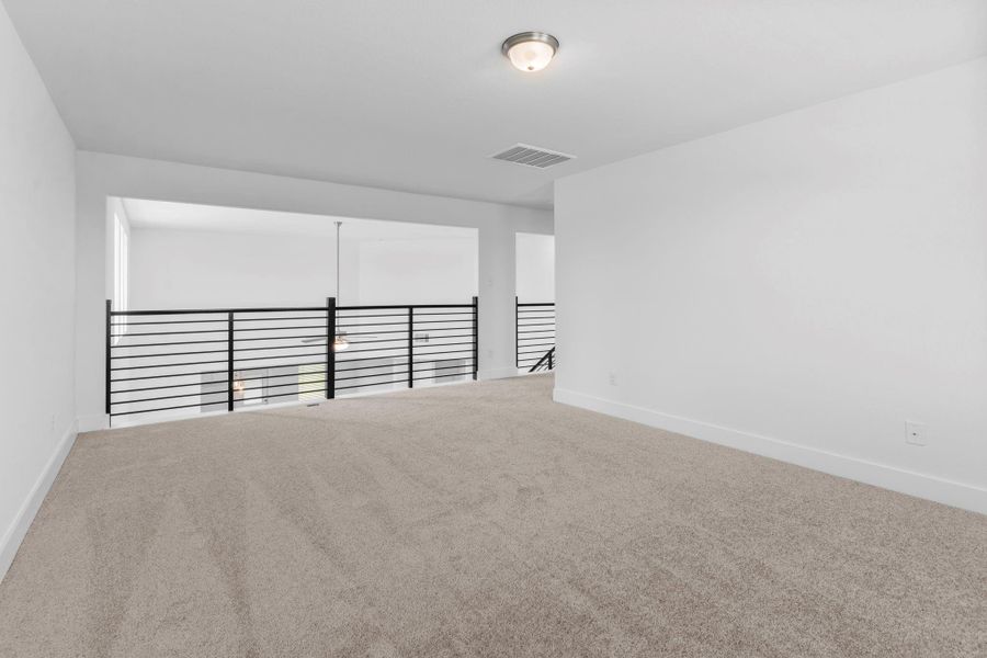 Loft-style overlook from the game room into the grand family room below, bringing in light and creating an airy, connected feel. Loft-style overlook from the game room into the grand family room below, bringing in light and creating an airy, connected feel.