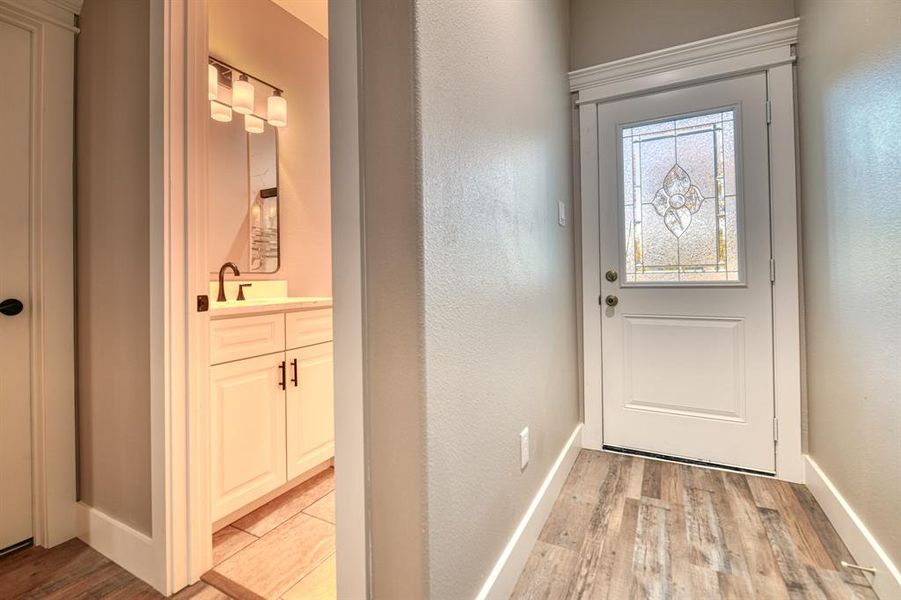Doorway to outside featuring wood finished floors and baseboards