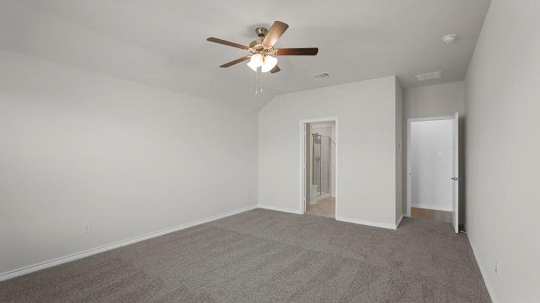 Spacious carpeted room featuring a ceiling fan with integrated lighting, neutral wall paint, and white trim
