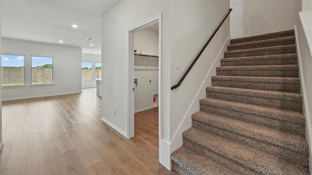 Stairs featuring recessed lighting and wood finished floors