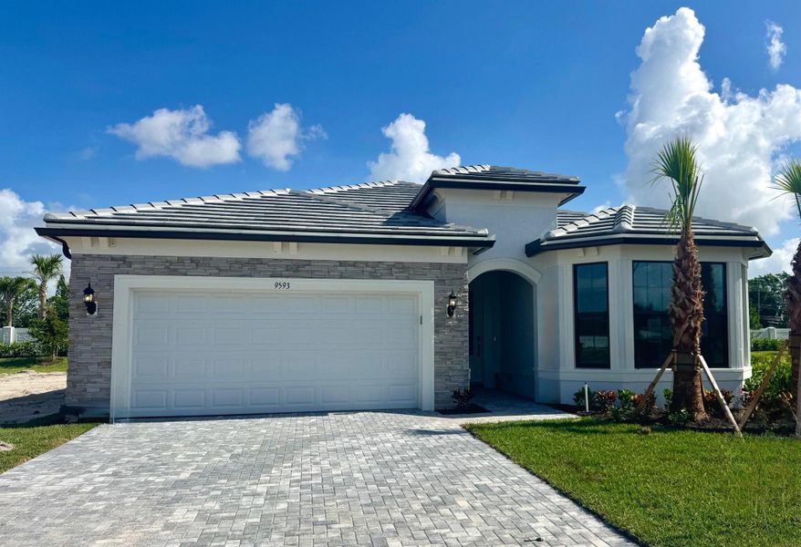 Front exterior of a new home in Hendrix Reserve, Lake Worth, FL, highlighting curb appeal (Image 14). Front exterior of a new home in Hendrix Reserve, Lake Worth, FL, highlighting curb appeal (Image 14).