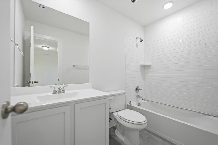 Full bathroom featuring vanity, washtub / shower combination, recessed lighting, and tile patterned floors