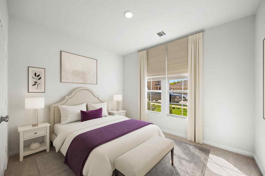 A bedroom with a bed and a window.