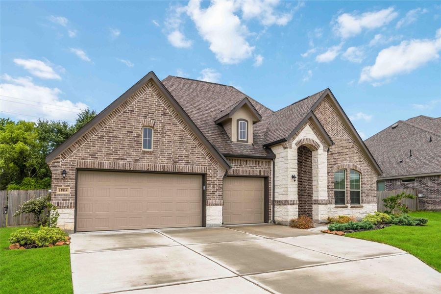Front exterior of a new home in Lakes of Champion's Estates, Mont Belvieu, TX, highlighting curb appeal (Image 1). Front exterior of a new home in Lakes of Champion's Estates, Mont Belvieu, TX, highlighting curb appeal (Image 1).
