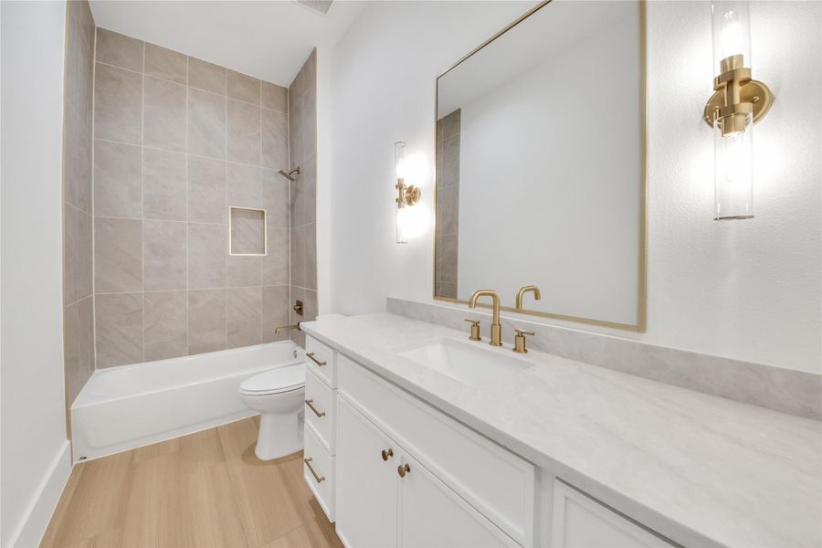 Beautifully designed secondary bathroom featuring a custom vanity, quartz countertops, modern fixtures, and quality finishes throughout. Beautifully designed secondary bathroom featuring a custom vanity, quartz countertops, modern fixtures, and quality finishes throughout.
