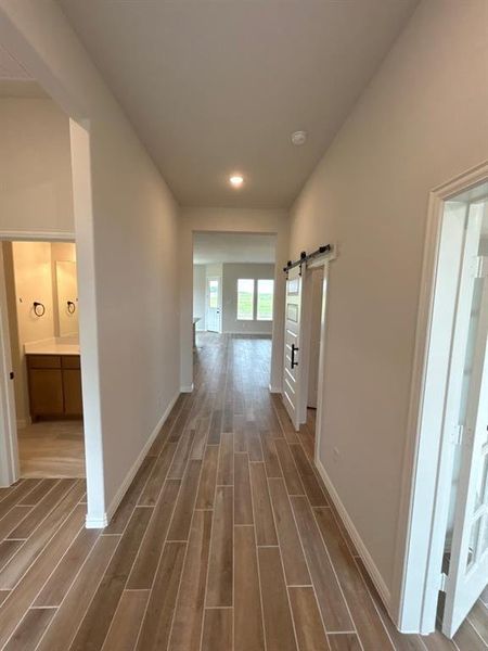Wood-finish tile flooring extending through the hallway