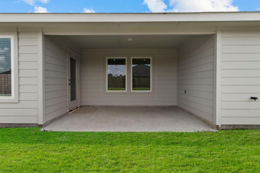 Exterior details and patio area of a home in The Canopies, Splendora (Image 4).