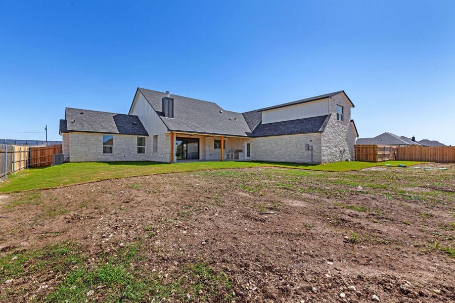 Rear view of house featuring a fenced backyard, a patio, and a shingled roof Rear view of house featuring a fenced backyard, a patio, and a shingled roof