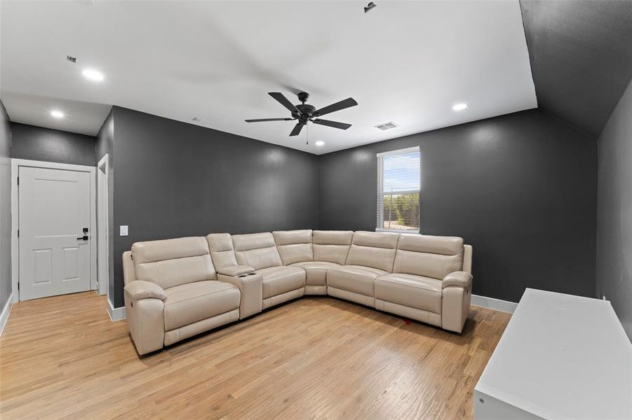 Living room featuring light wood-style flooring, recessed lighting, and ceiling fan Living room featuring light wood-style flooring, recessed lighting, and ceiling fan