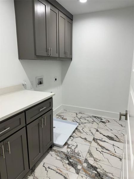 Clothes washing area with hookup for a washing machine, hookup for an electric dryer, and cabinets