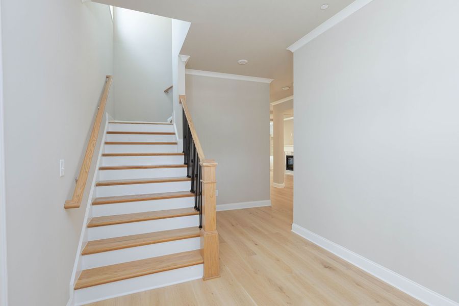 The entryway foyer opens into the stairs and the formal dining room