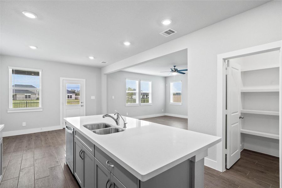 From the expansive kitchen island, enjoy seamless sightlines across the open-concept living and dining areas, making entertaining a breeze and ensuring you're never far from the conversation. From the expansive kitchen island, enjoy seamless sightlines across the open-concept living and dining areas, making entertaining a breeze and ensuring you're never far from the conversation.