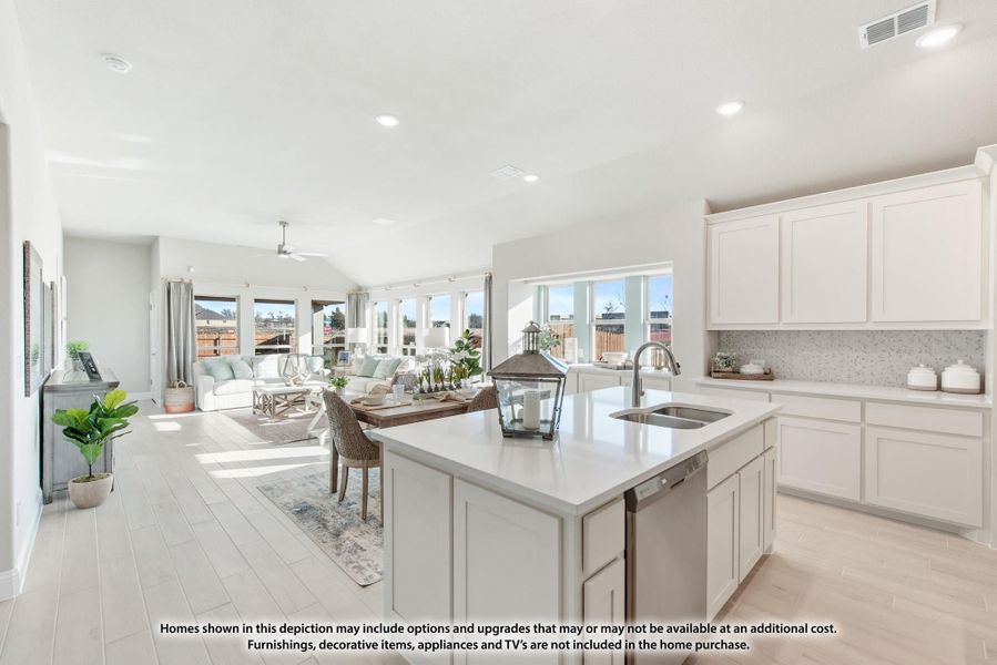 Open-concept kitchen with white cabinets, center island with sink, and living room beyond Open-concept kitchen with white cabinets, center island with sink, and living room beyond