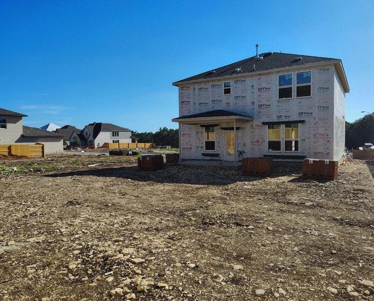 Front exterior of a new home in Woodside, Georgetown, TX, highlighting curb appeal (Image 1).