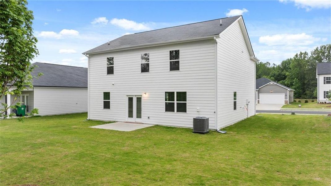 Front exterior of a new home in Champion's Run, Lithonia, GA, highlighting curb appeal (Image 27).