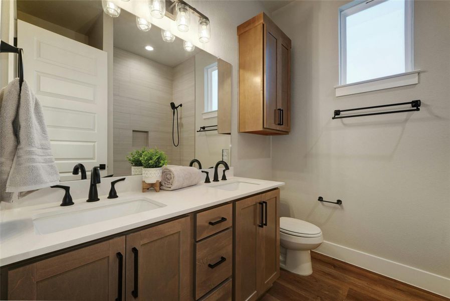 Dual vanity featuring undermount sinks, white countertops, and matte black fixtures