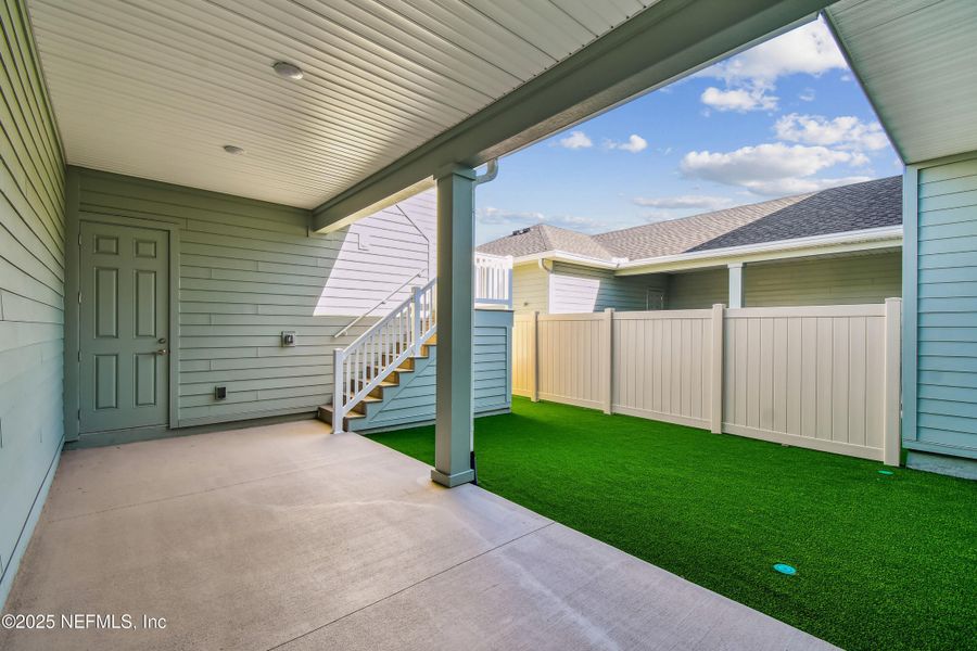 Exterior details and patio area of a home in Seven Pines 24' Rear Entry Townhomes, Jacksonville (Image 1).