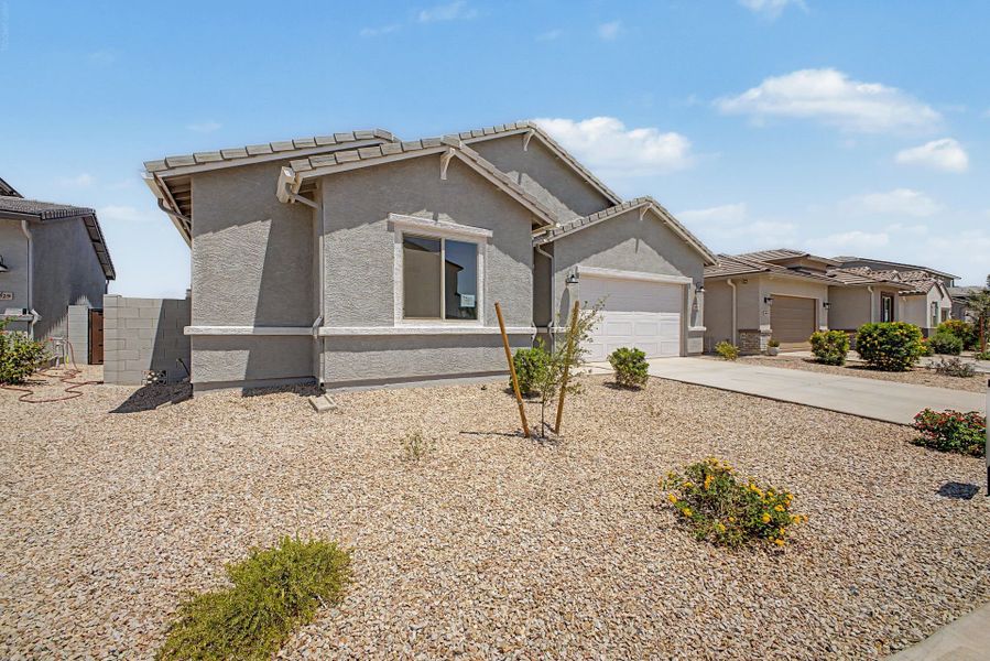 Front exterior of a new home in Wildera, San Tan Valley, AZ, highlighting curb appeal (Image 2). Front exterior of a new home in Wildera, San Tan Valley, AZ, highlighting curb appeal (Image 2).