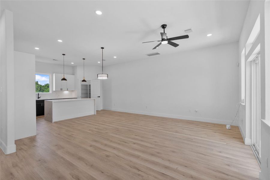 Expansive open concept living and dining area on the second floor designed for effortless entertaining with refined modern elegance Expansive open concept living and dining area on the second floor designed for effortless entertaining with refined modern elegance