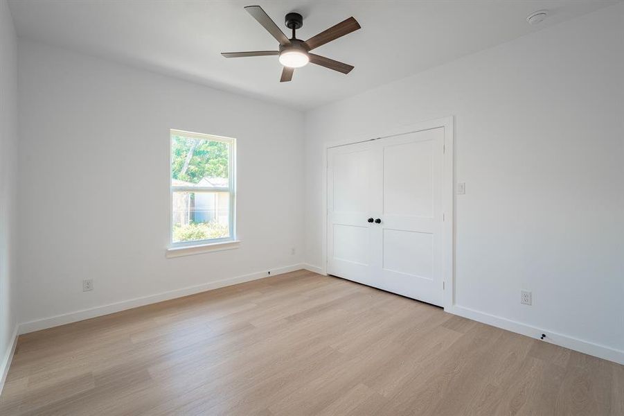 Unfurnished bedroom featuring light wood-style floors, a closet, and ceiling fan Unfurnished bedroom featuring light wood-style floors, a closet, and ceiling fan