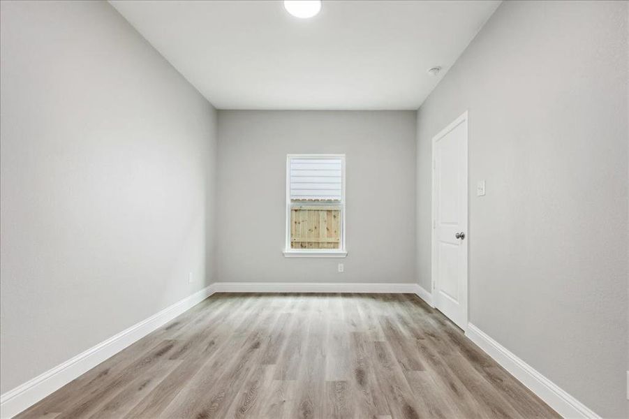 Spare room with light wood-type flooring