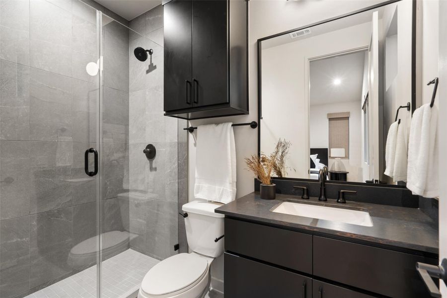 A well-appointed bathroom with dark fixtures and sleek tiled shower, maximizing style and utility. A well-appointed bathroom with dark fixtures and sleek tiled shower, maximizing style and utility.