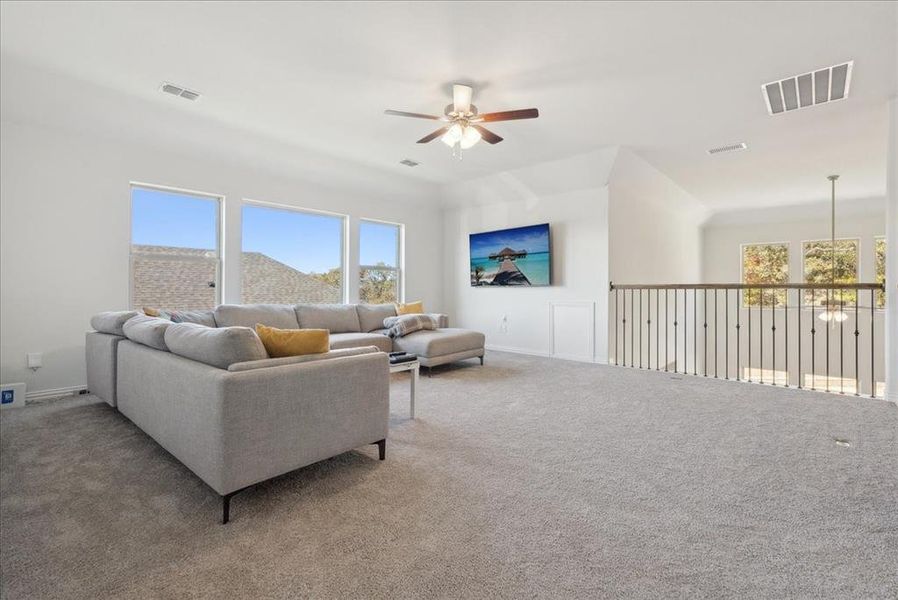 Living room featuring carpet and ceiling fan