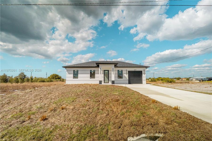 Front exterior of a new home in , Lehigh Acres, FL, highlighting curb appeal (Image 2). Front exterior of a new home in , Lehigh Acres, FL, highlighting curb appeal (Image 2).