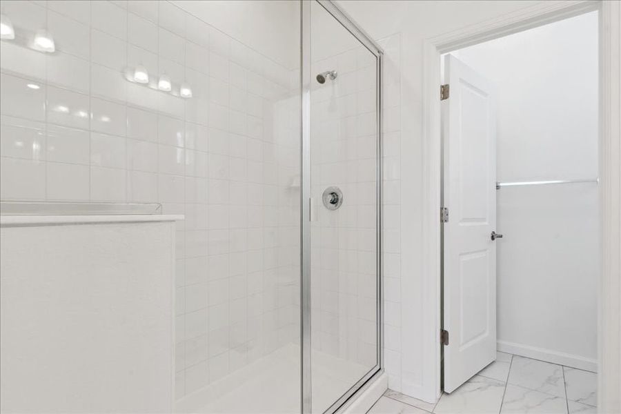 A shower with glass doors.