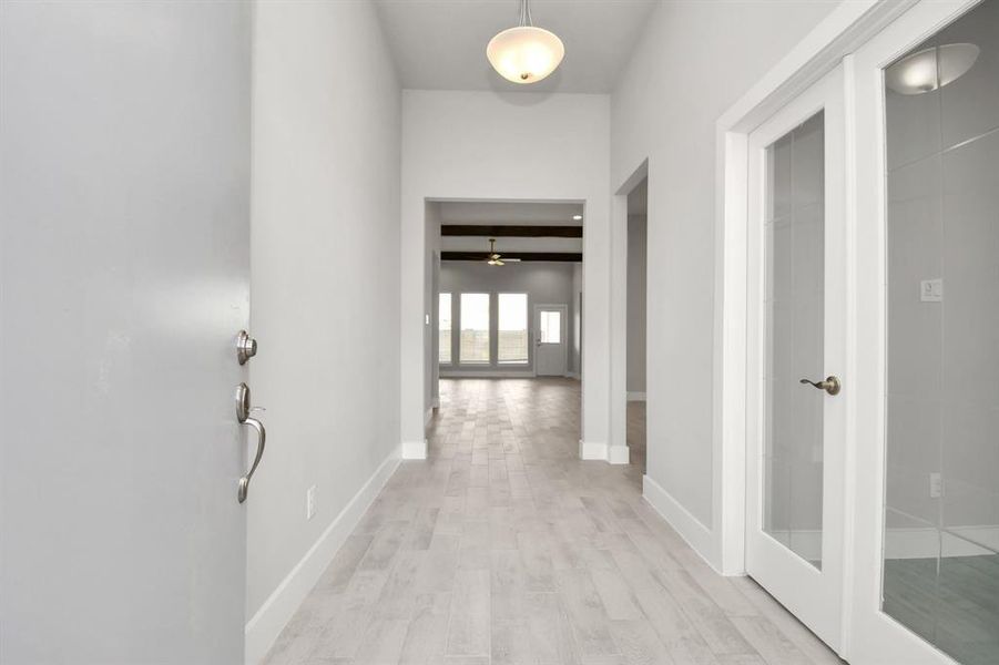 As you step into the threshold of this luxurious home, you'll soon be welcomed by an elegant glass door (to be installed). Inside, soaring ceilings amplify the spaciousness, while the refined wood-look tile flooring and oversized baseboards.