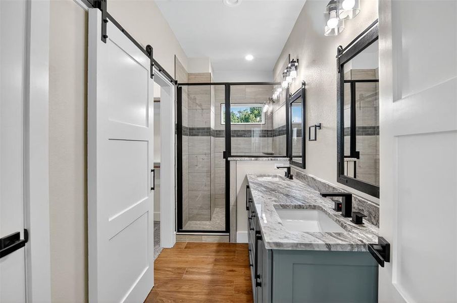 primary bathroom, granite counters, dual sinks, separate shower, walk in closet