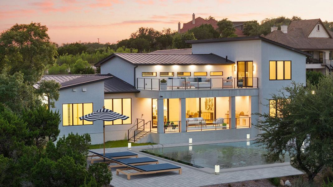 Virtually staged exterior showcasing multiple balconies overlooking a private pool, perfect for entertaining.