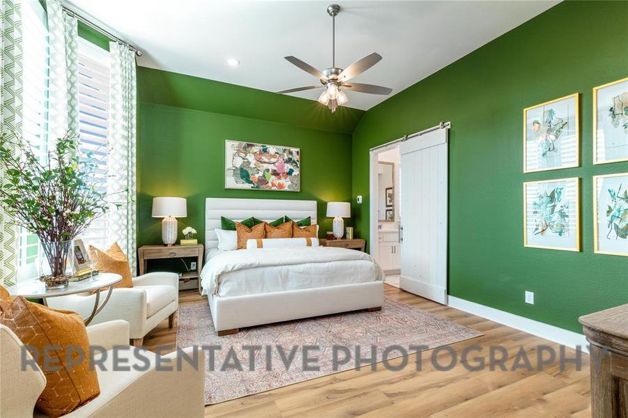 Bedroom with lofted ceiling, wood finished floors, ceiling fan, and recessed lighting Bedroom with lofted ceiling, wood finished floors, ceiling fan, and recessed lighting