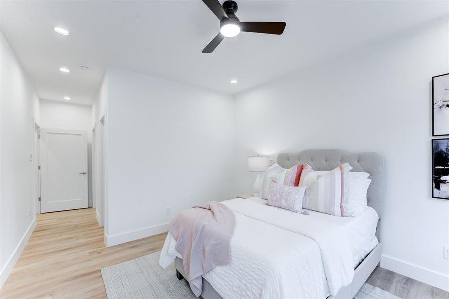 Secondary bedroom with luxury vinyl plank flooring, recessed lighting, ceiling fan, and neutral toned walls.