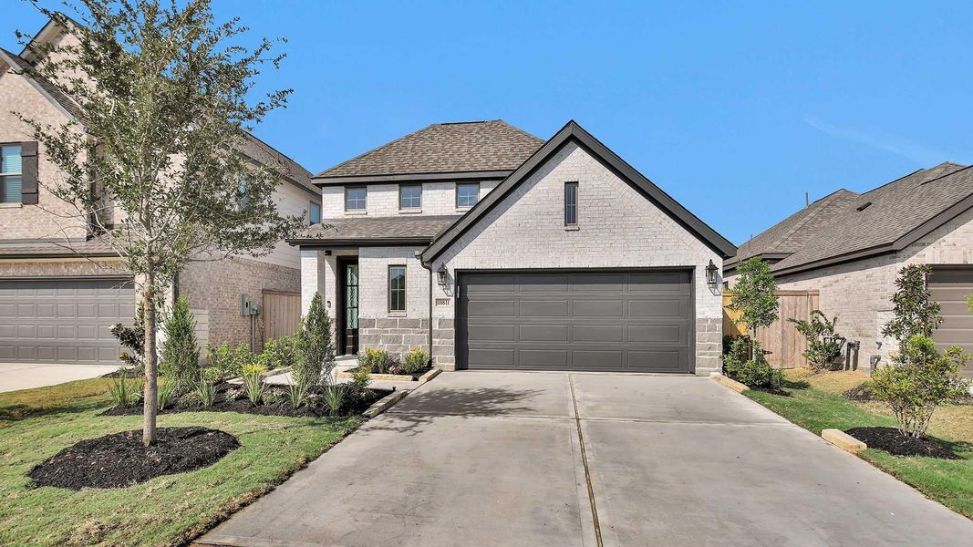 Front exterior of a new home in Candela 40', Richmond, TX, highlighting curb appeal (Image 1).