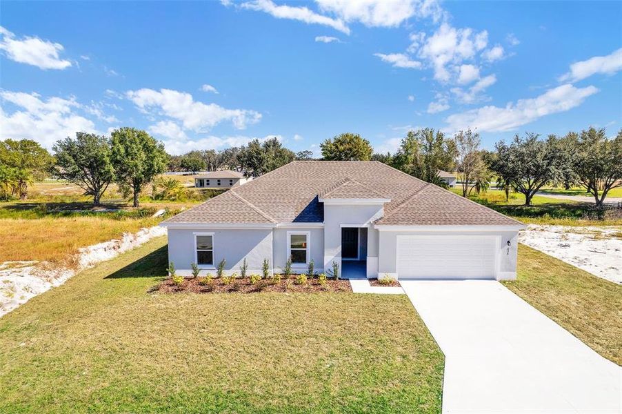 Front exterior of a new home in Grand Oaks, Avon Park, FL, highlighting curb appeal (Image 1). Front exterior of a new home in Grand Oaks, Avon Park, FL, highlighting curb appeal (Image 1).