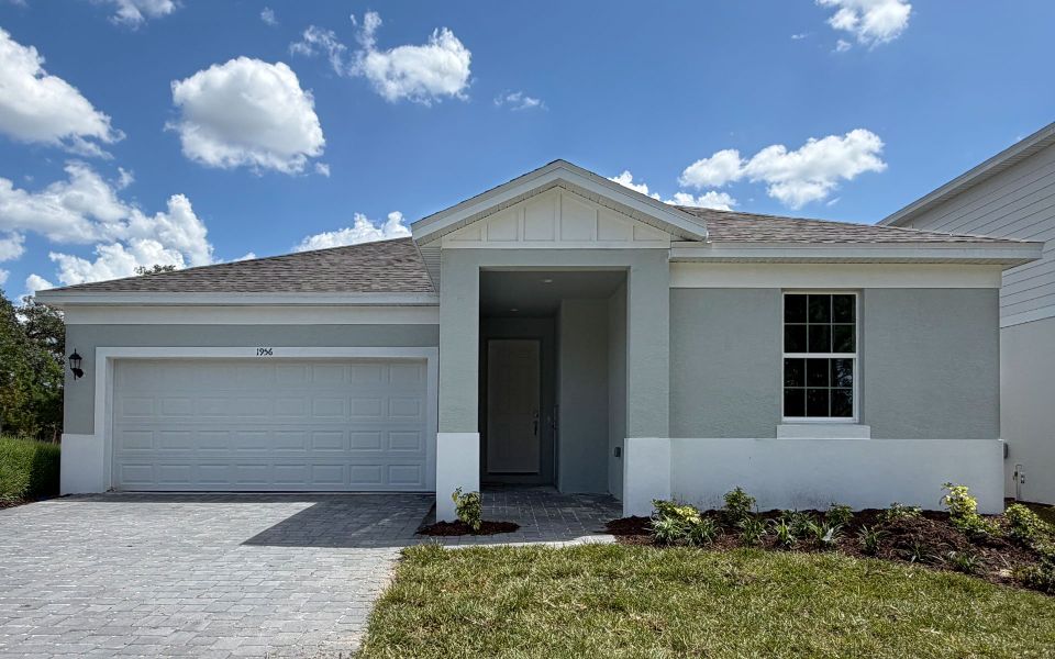 Front exterior of a new home in Trinity Gardens, Deland, FL, highlighting curb appeal (Image 1). Front exterior of a new home in Trinity Gardens, Deland, FL, highlighting curb appeal (Image 1).