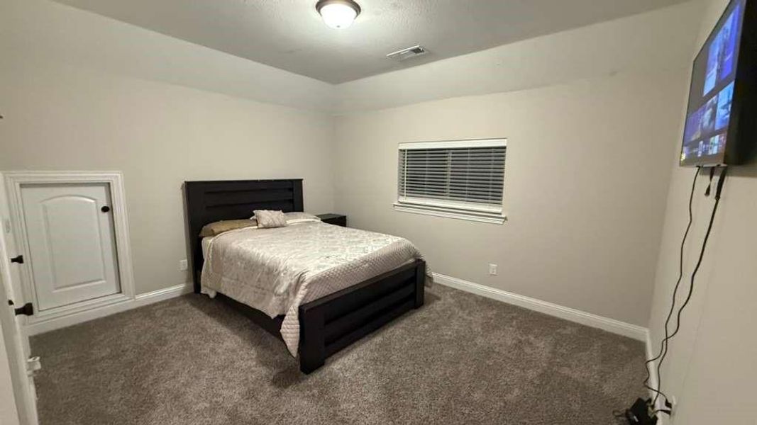 Carpeted bedroom with baseboards