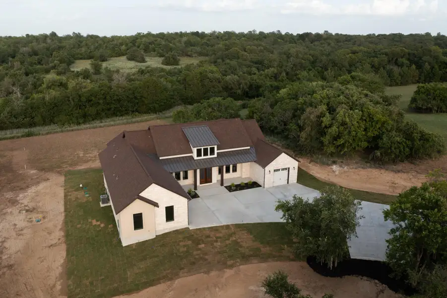 Aerial view of property and surrounding area with a heavily wooded area Aerial view of property and surrounding area with a heavily wooded area