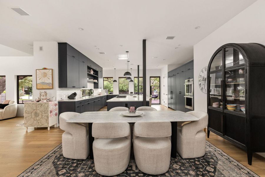 An open concept design seamlessly connects the dining area to a well-appointed kitchen. An open concept design seamlessly connects the dining area to a well-appointed kitchen.
