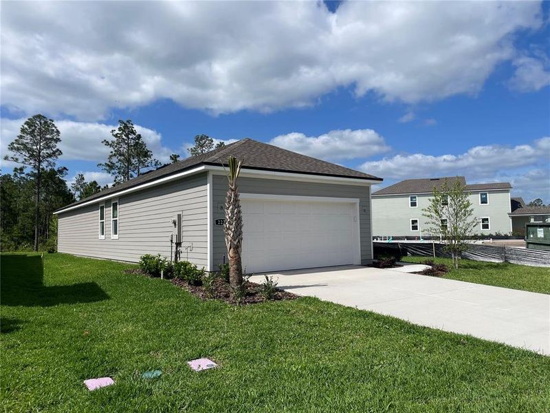 Front exterior of a new home in Palm Series at Seminole Palms, Palm Coast, FL, highlighting curb appeal (Image 2).