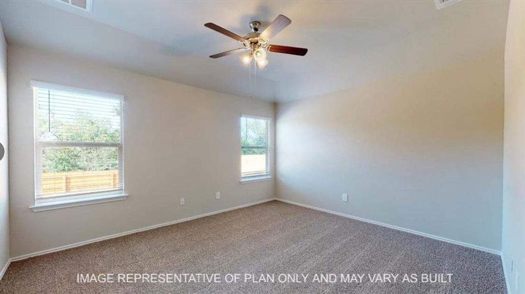 Carpeted spare room featuring baseboards and a ceiling fan