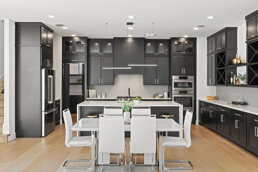 The great room open floor plan offers space for a large dining table betweent he kitchen and living area, perfect for entertaining and connectivity.