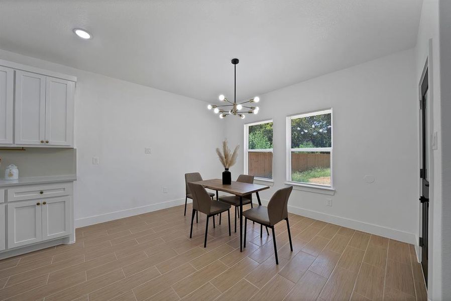 Dining area featuring tiled floors, a chandelier, and recessed lighting