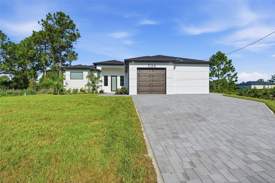 Front exterior of a new home in , Lehigh Acres, FL, highlighting curb appeal (Image 2). Front exterior of a new home in , Lehigh Acres, FL, highlighting curb appeal (Image 2).